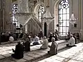 Muslim men praying at the Ortaköy Mosque in Istanbul