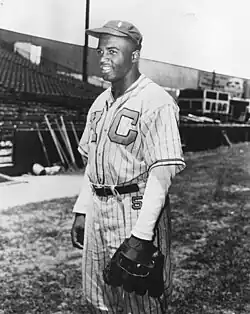 Robinson posing in the uniform cap of the Kansas City Monarchs, a Negro League baseball team, 1945